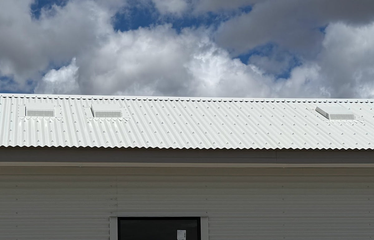 Three Dragon Vents Australia DV350LP low-profile rangehood roof vents installed on a white corrugated metal roof of a modular-style building.